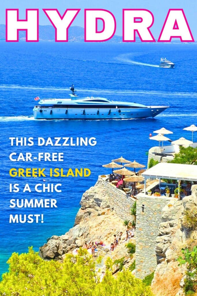 Image of mega yacht arriving in hydra island greece past a seaside cafe