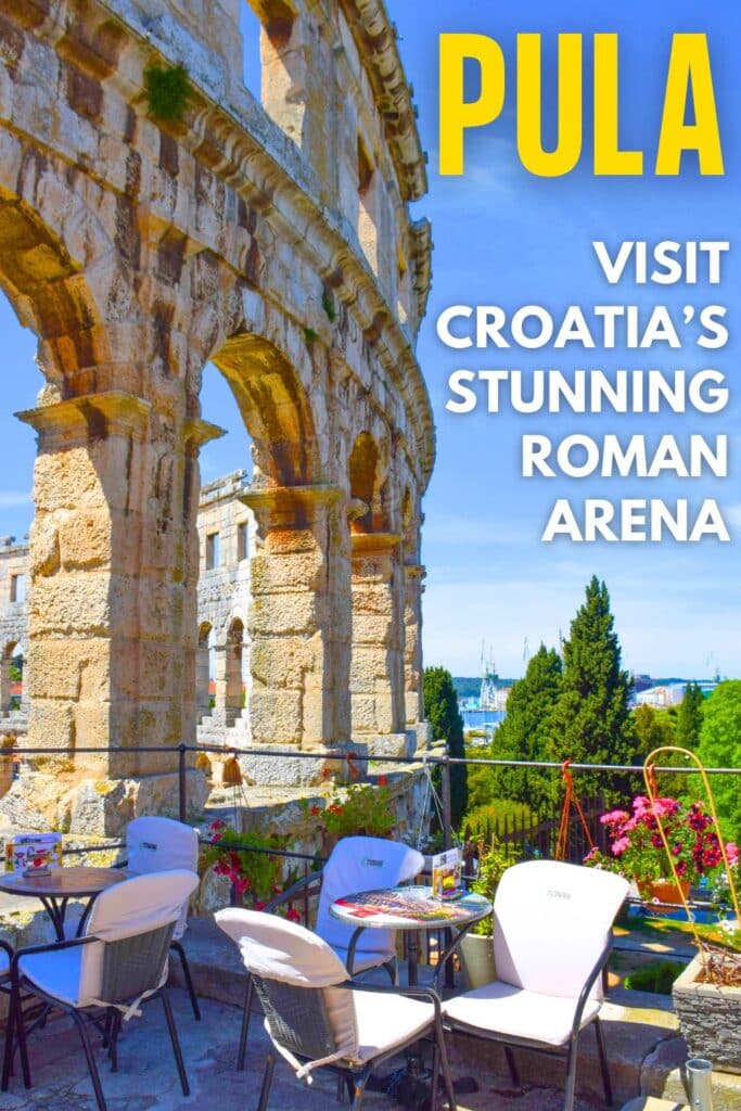 Cafe tables on a terrace overlooking the exterior walls of the Pula Arena in Croatia