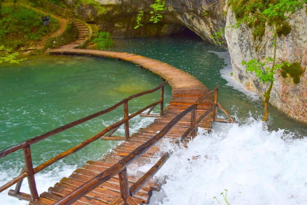 A partially submerged wooden path across a lake at Croatia's Plitvice Lakes National Park