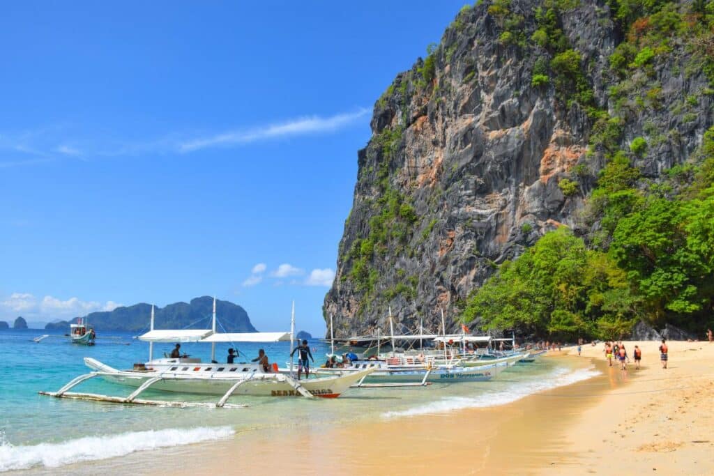 Philippine fishing boat on a white sand beach El Nido Palawan