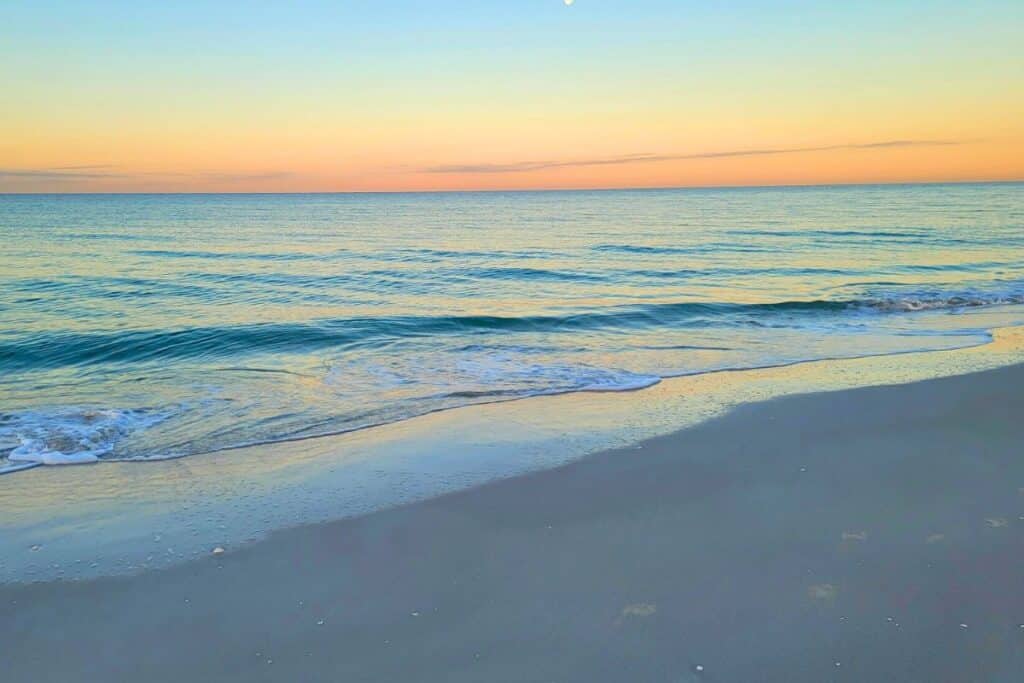 Pink sky at sunrise on the beach at Casey Key
